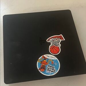 Black Gaming Console with Stickers PlayStation 4